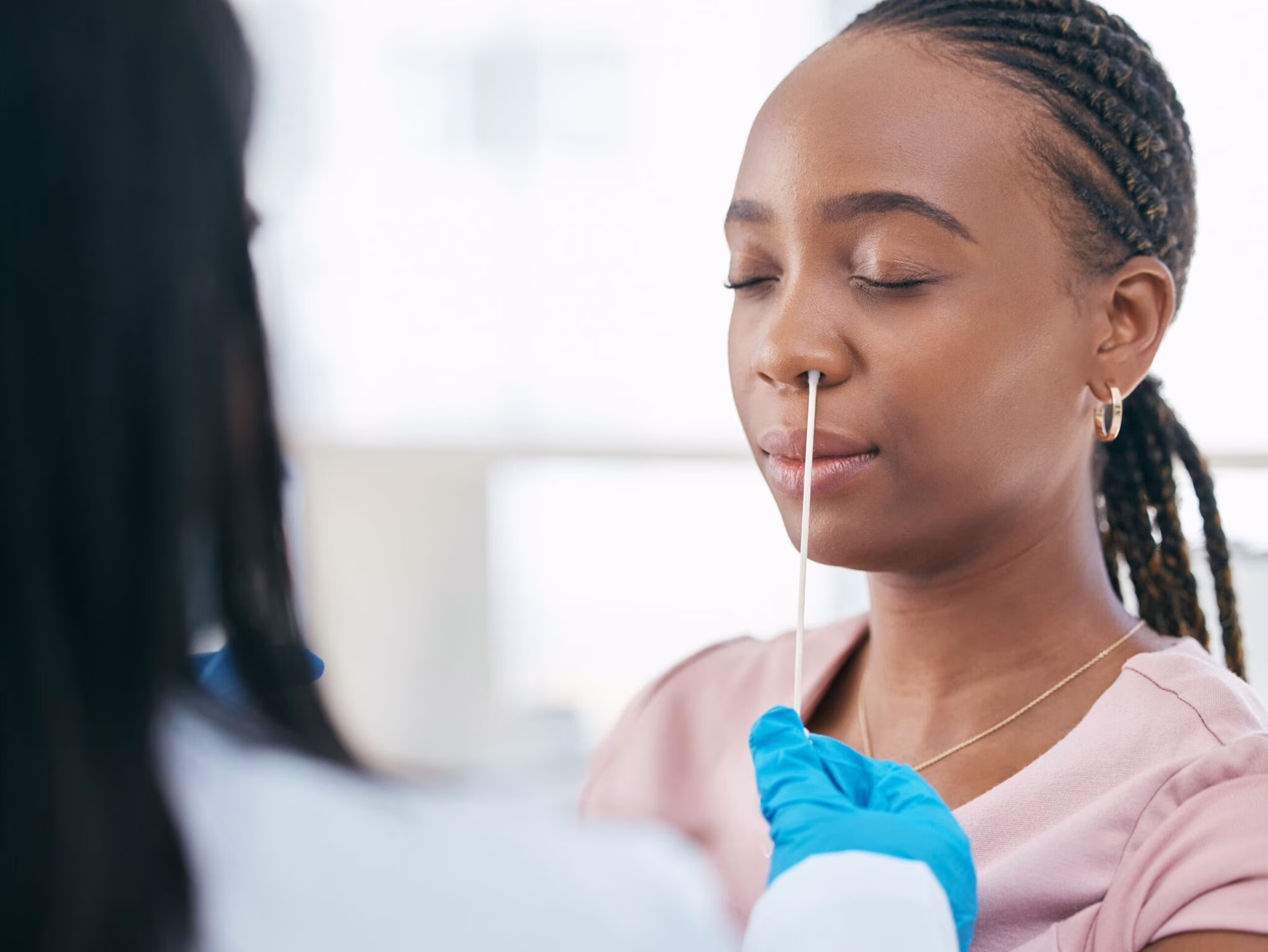Woman getting a COVID test by a medical provider