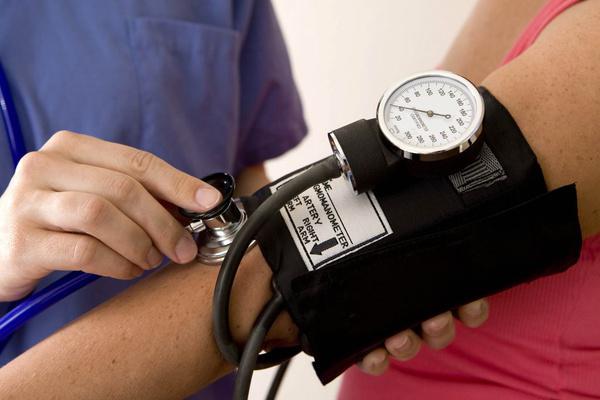 Provider taking a patient's blood pressure