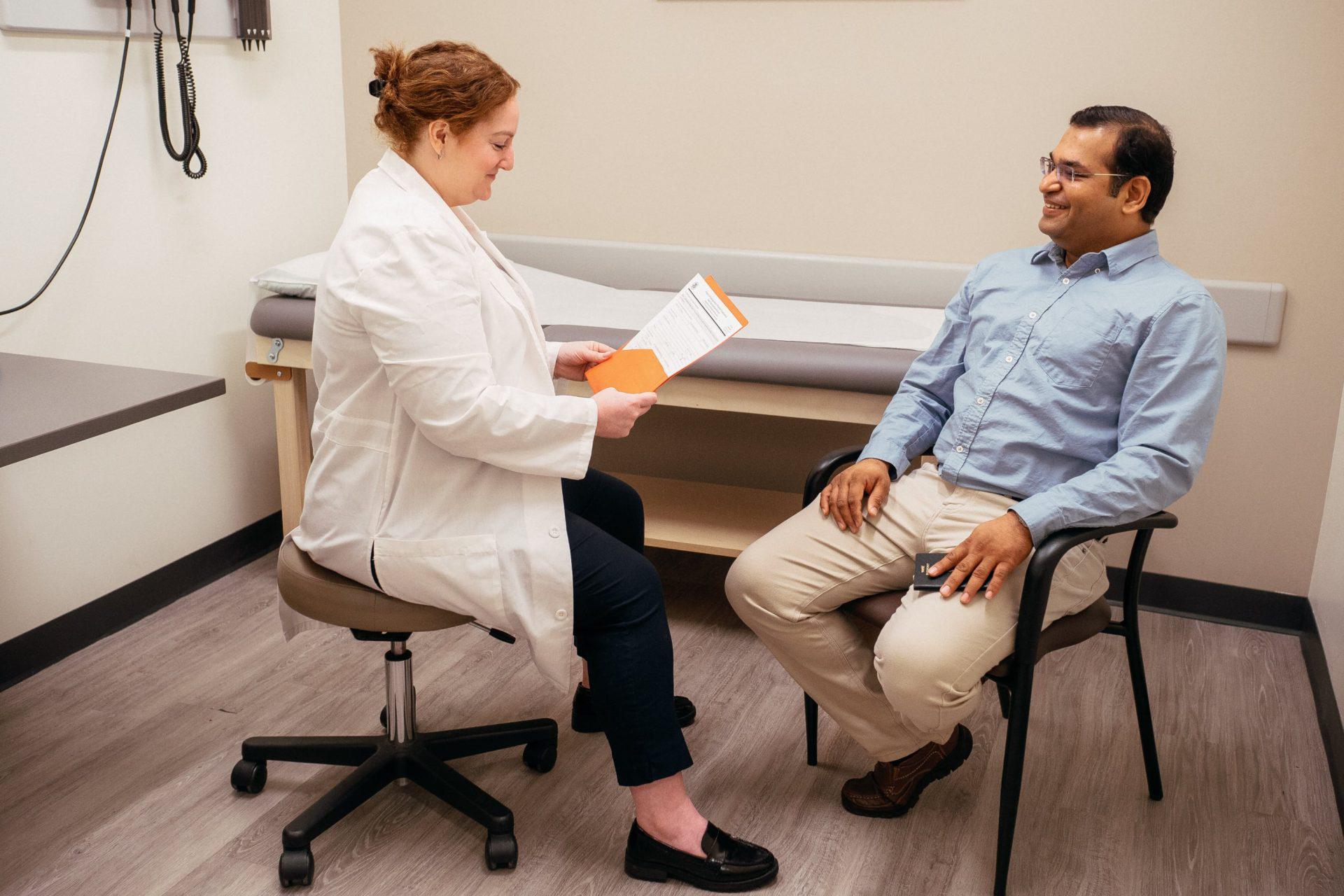 AFC physician reviews immigration physical paperwork