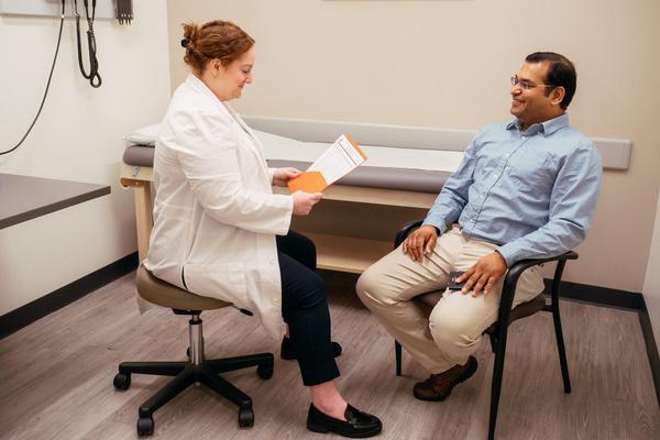 AFC provider reviewing immigration physical paperwork with a patient