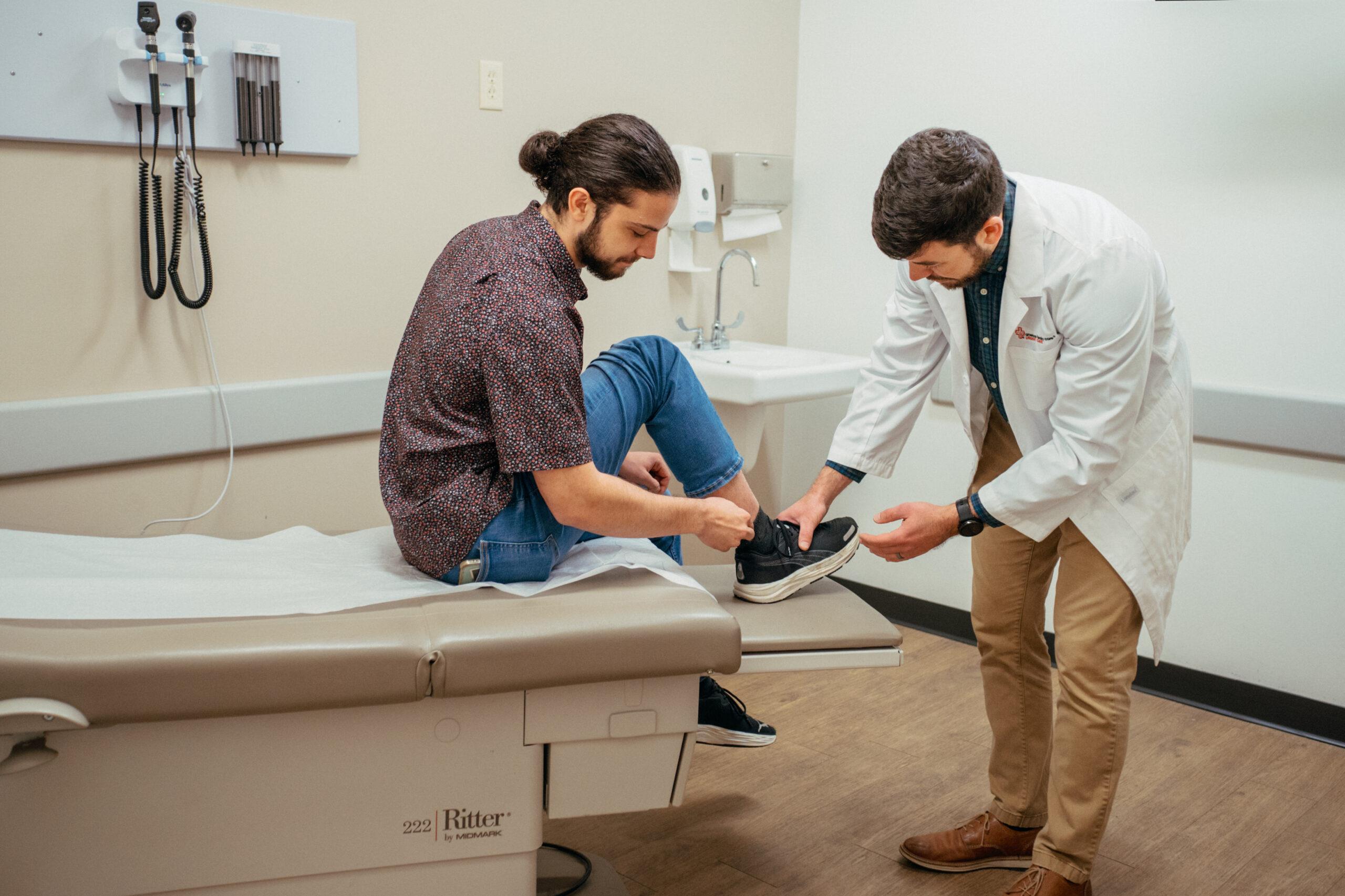 Patient getting their foot checked by the doctor.