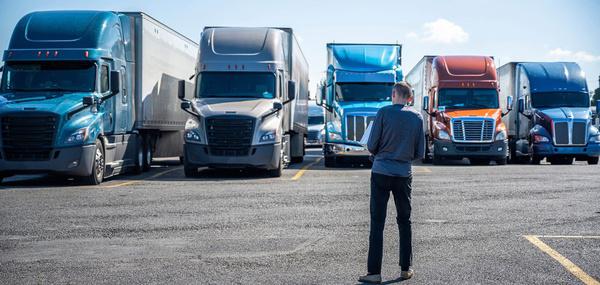 Row of semi trucks parked in a lot