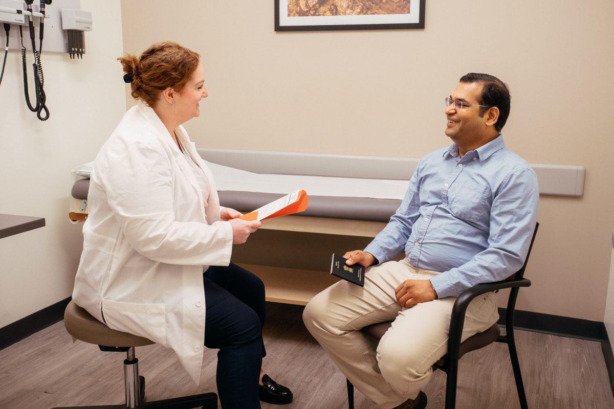 AFC physician reviews immigration physical paperwork 