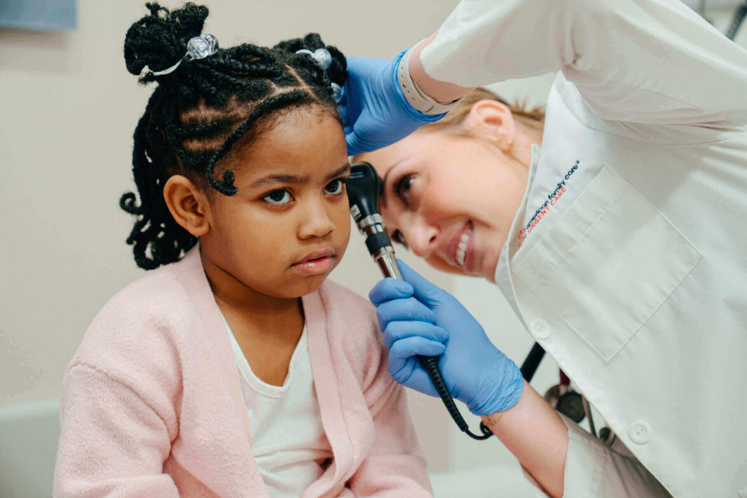 child receiving ear exam in an urgent care