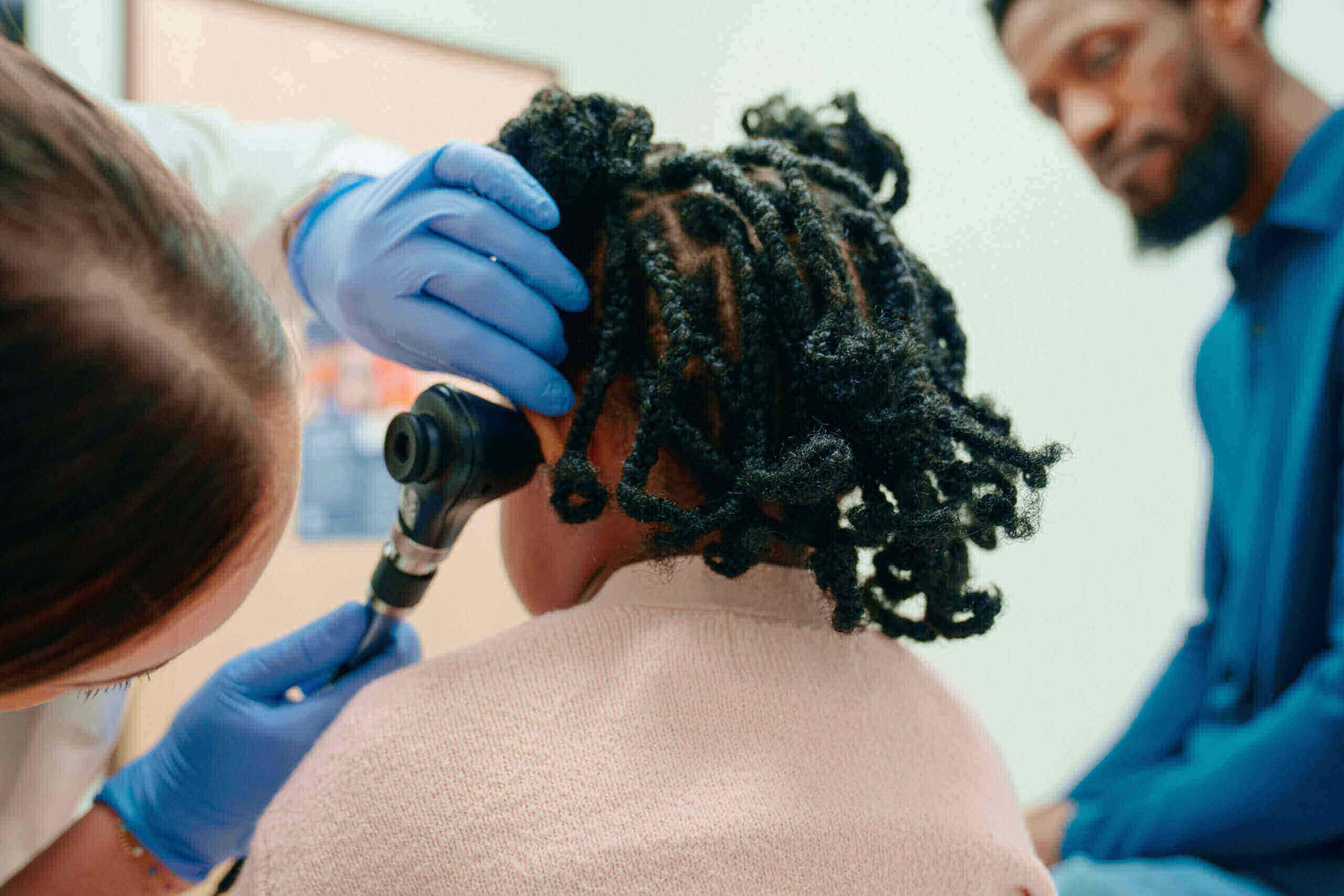 Little girl receiving ear check at an AFC Urgent Care clinic