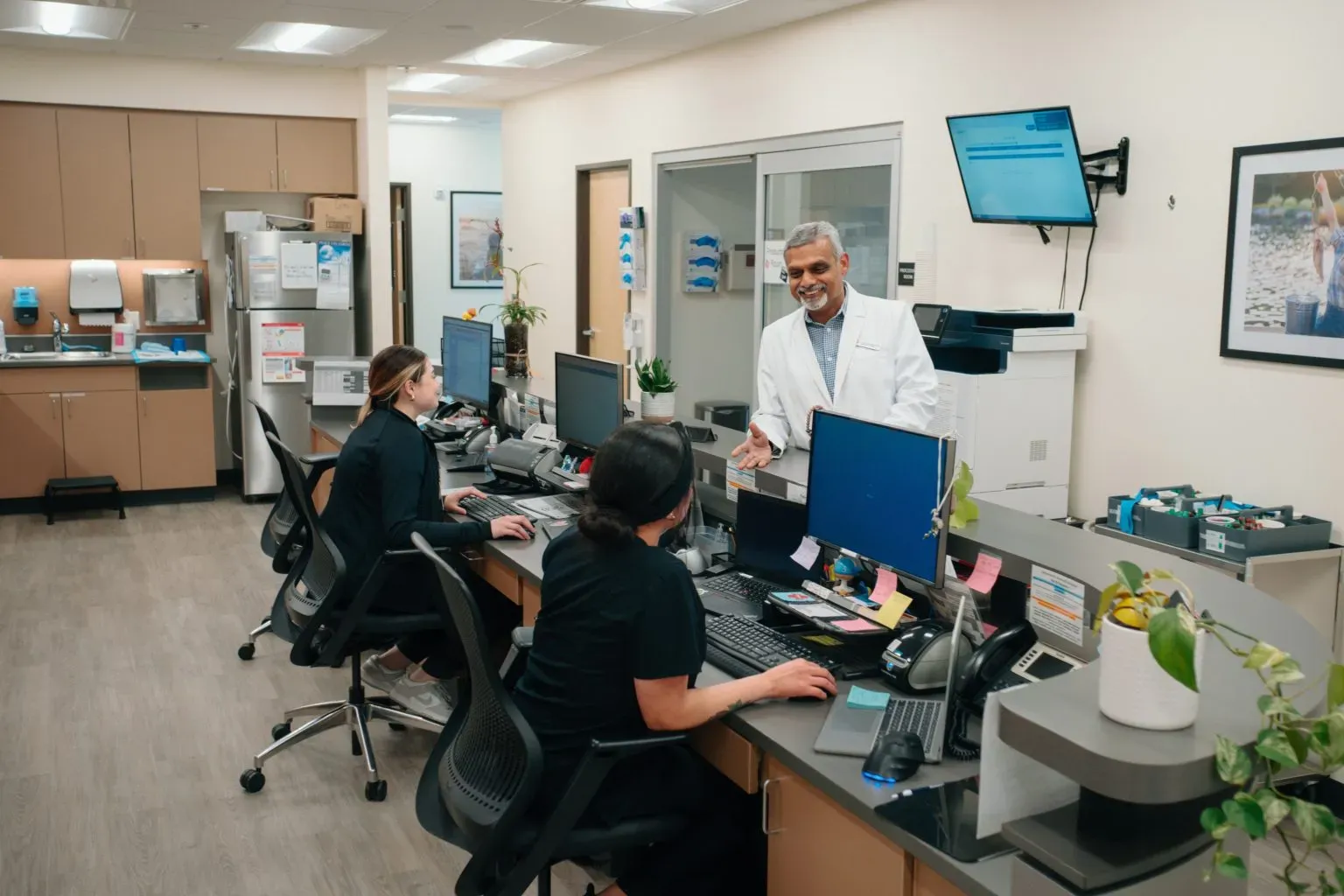 AFC staff talking to each other around desk station
