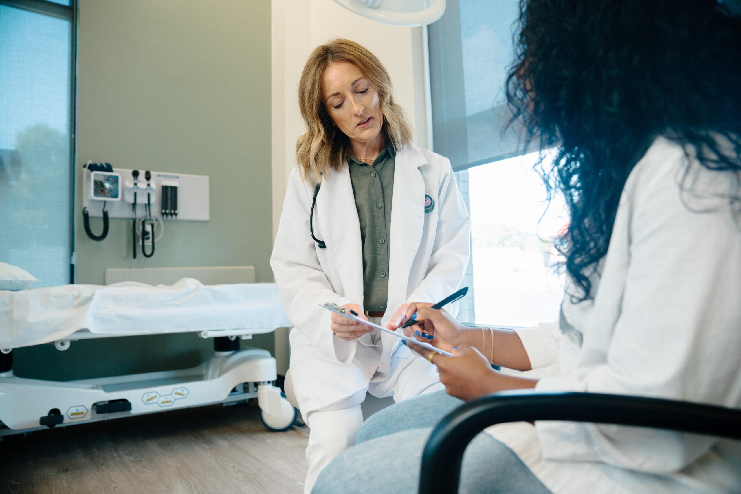 Woman receiving physical in an urgent care