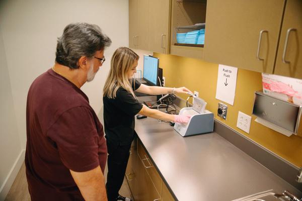 AFC staff member collecting a sample for a drug screen