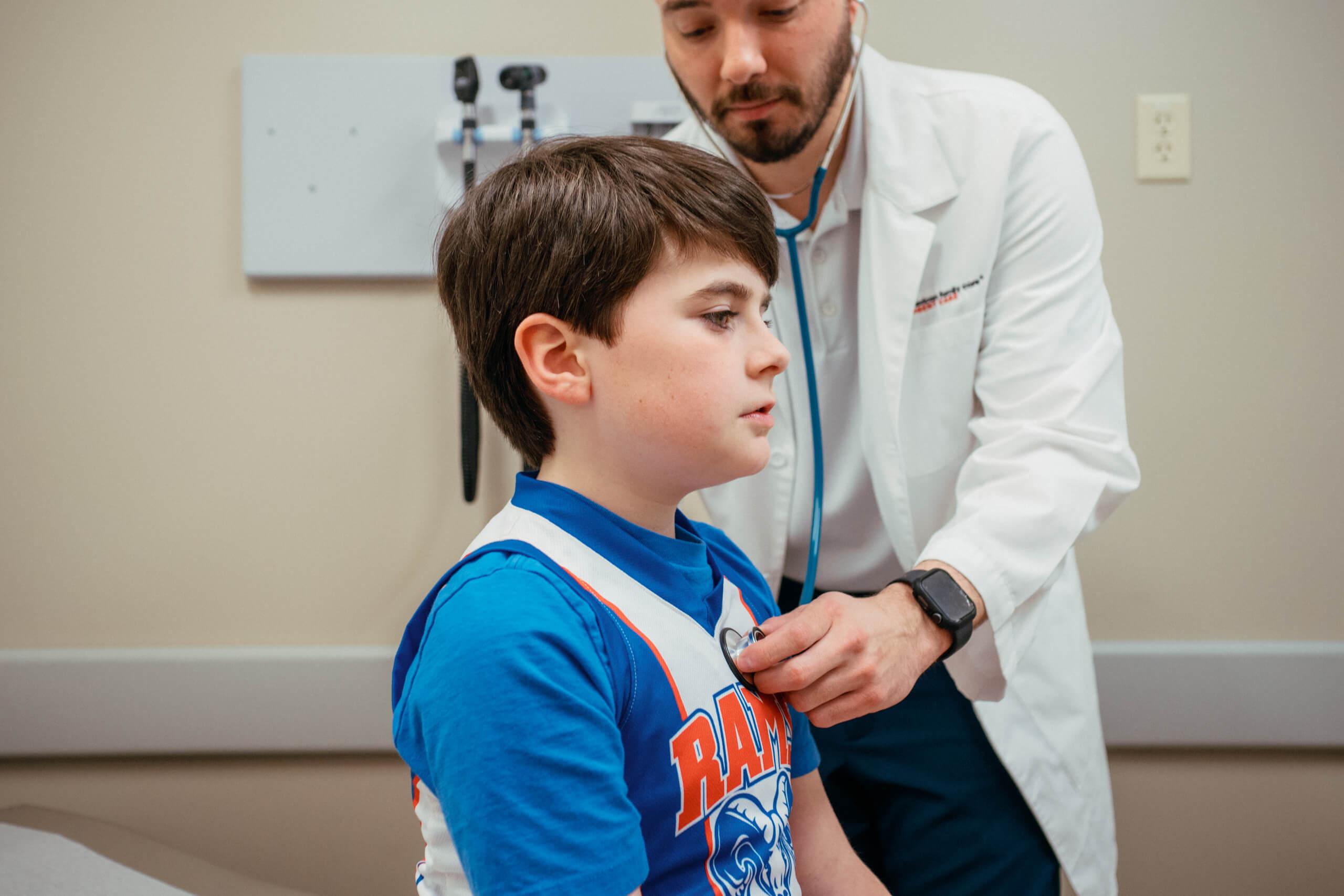 A young boy is checked by AFC healthcare provider for rhinovirus. 