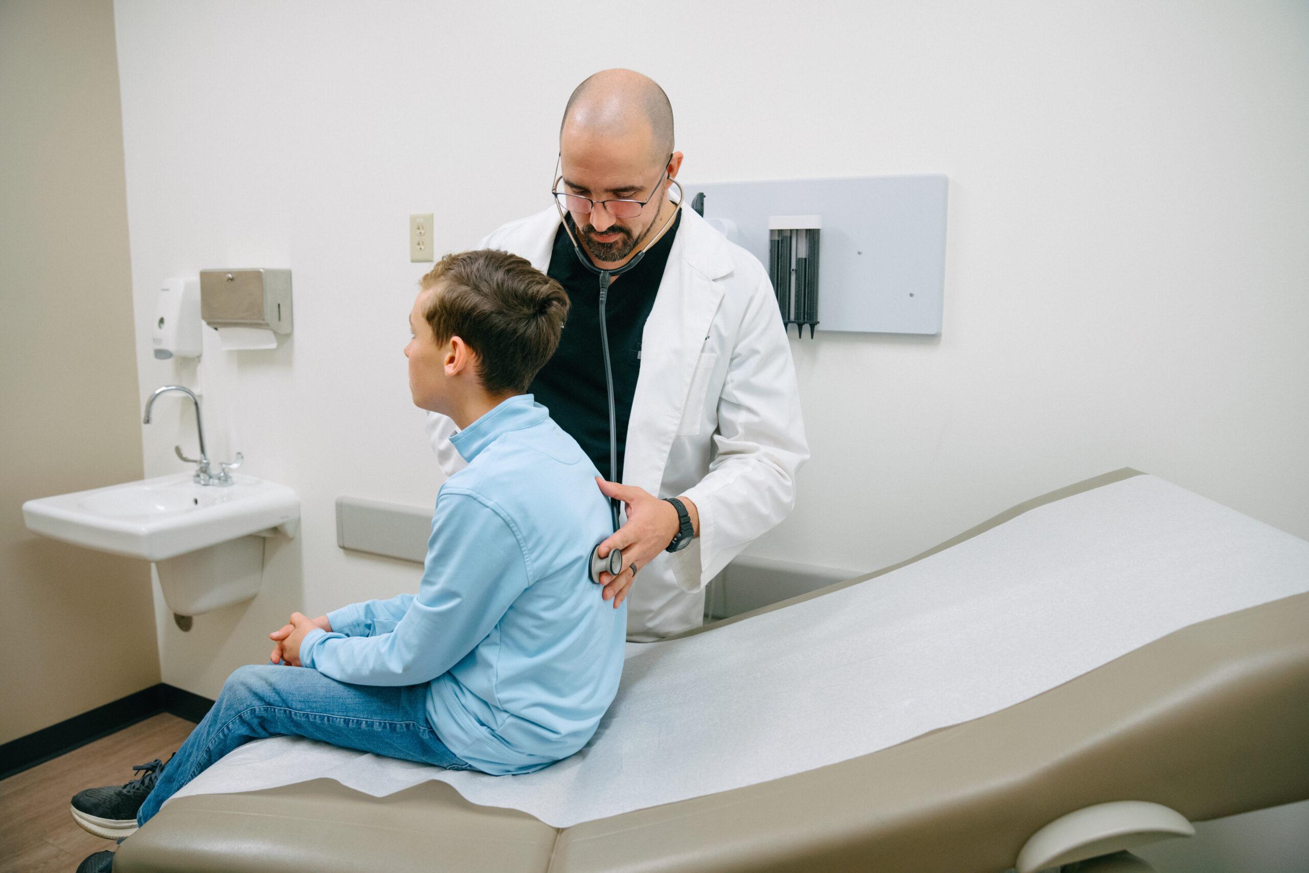 AFC healthcare provider checks young child for pneumonia.