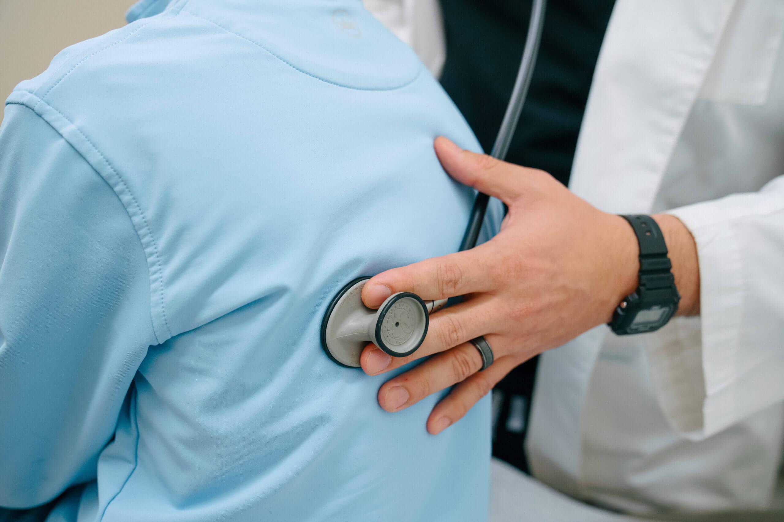 AFC healthcare provider checks young child for pneumonia.