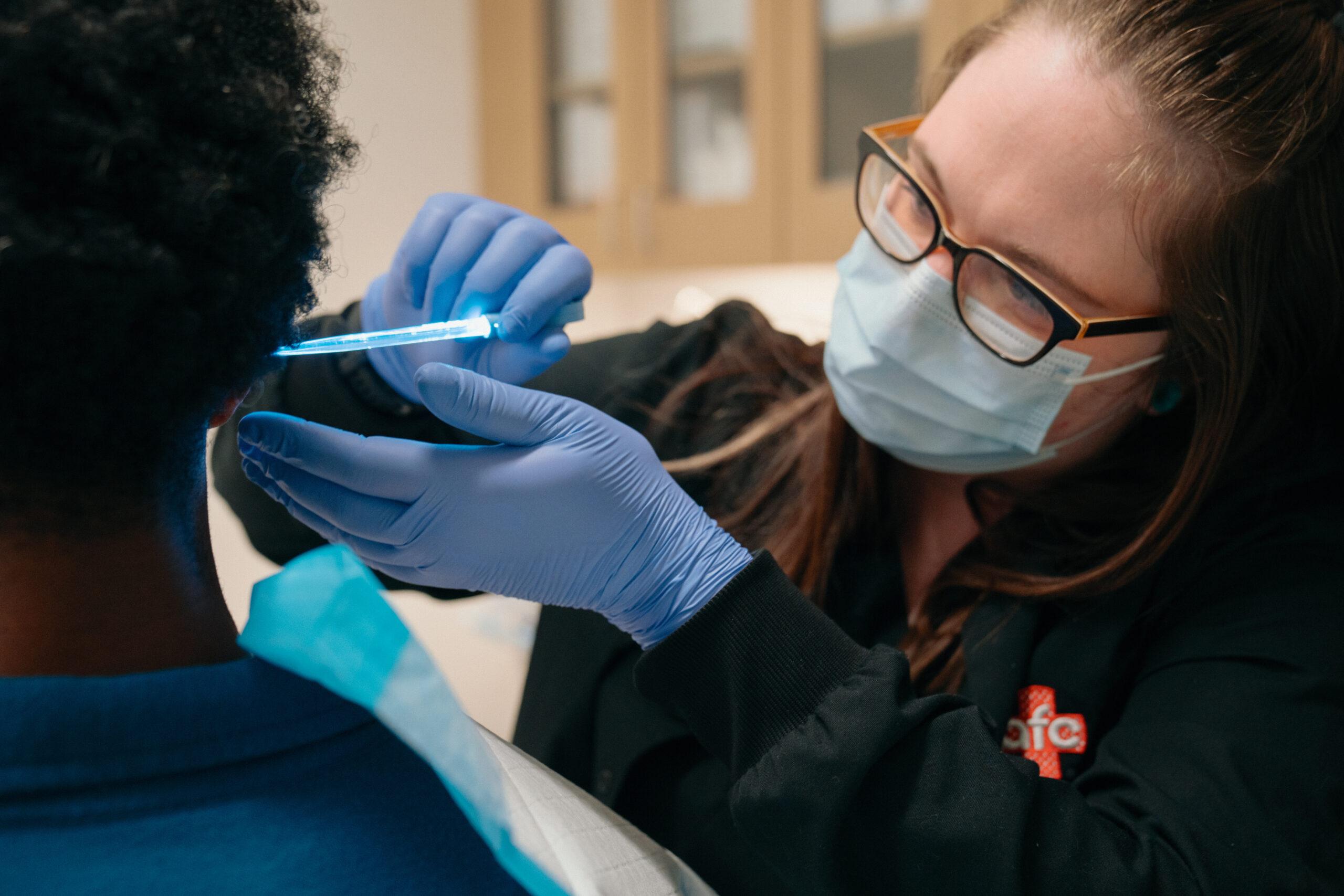 man receiving an ear cleaning at an urgent care