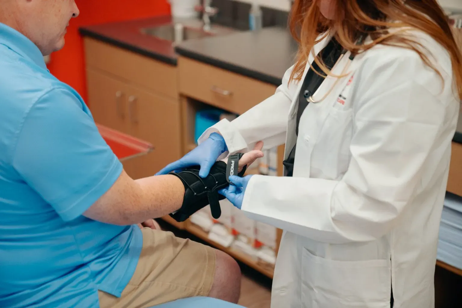 Medical provider treating wrist injury at AFC Fort Collins Medical provider treating wrist injury at AFC Fort Collins