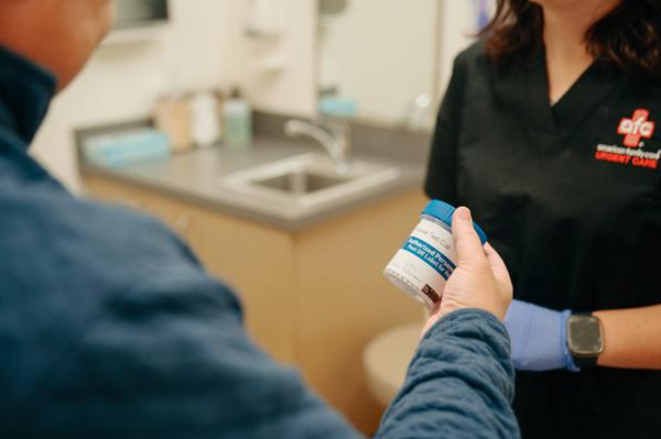 AFC staff member handling a patient sample for STD testing