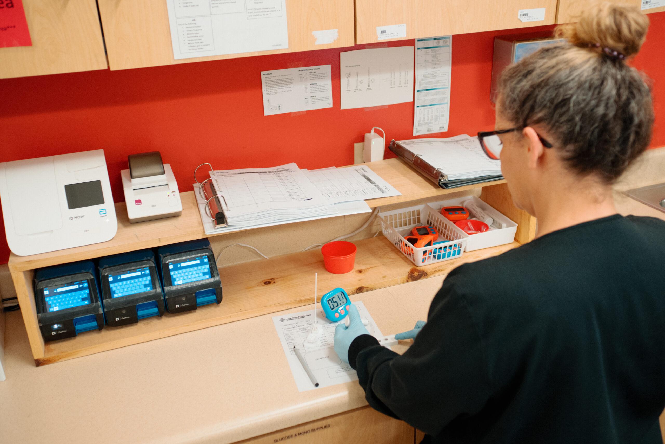 Female AFC technician performing labs given on-site at an AFC urgent care clinic location.