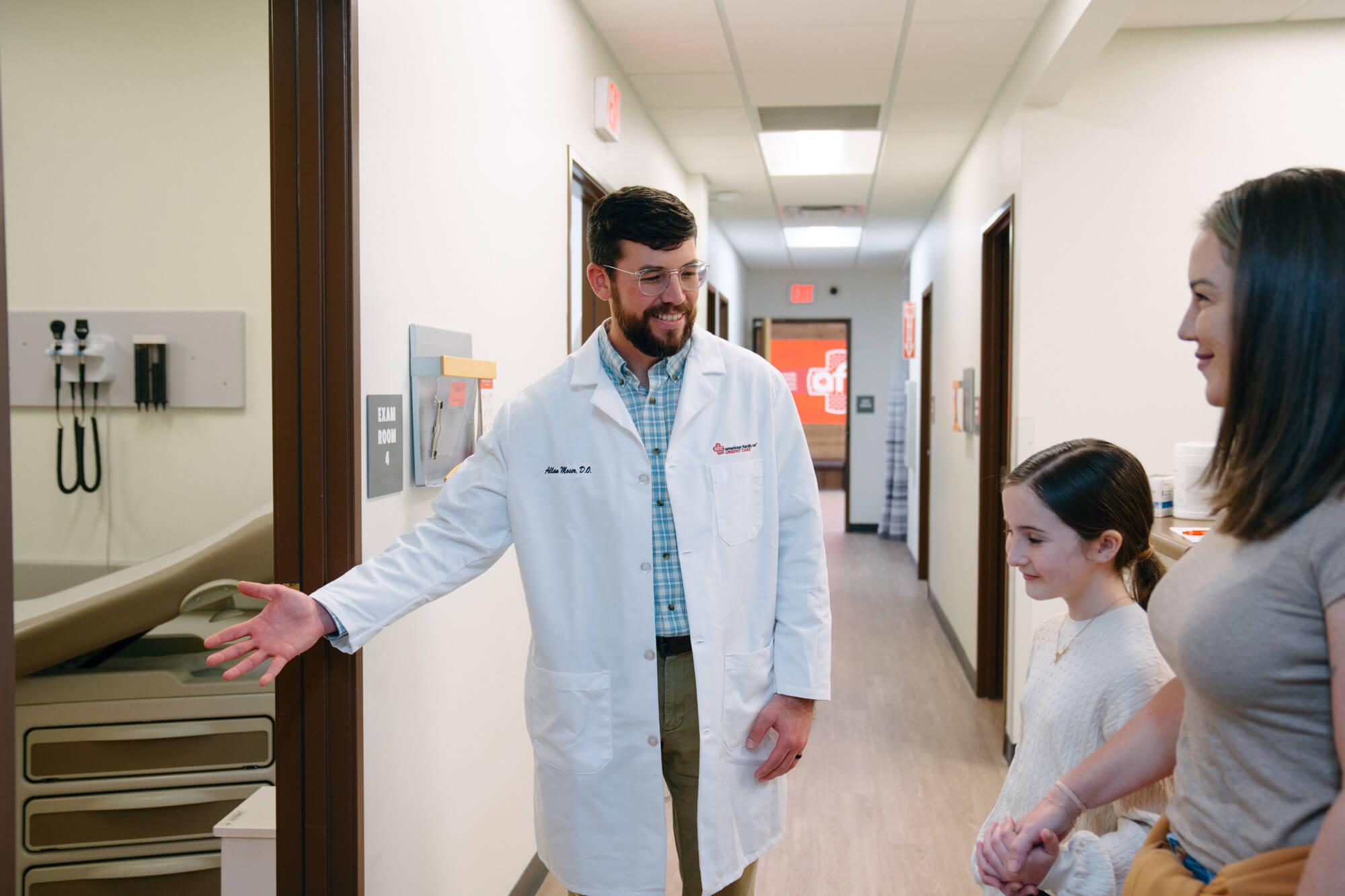 Medical provider shows patients to check-up room.