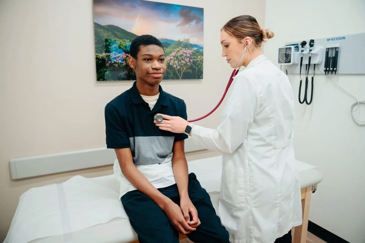 Physician listening to patient heart with stethoscope