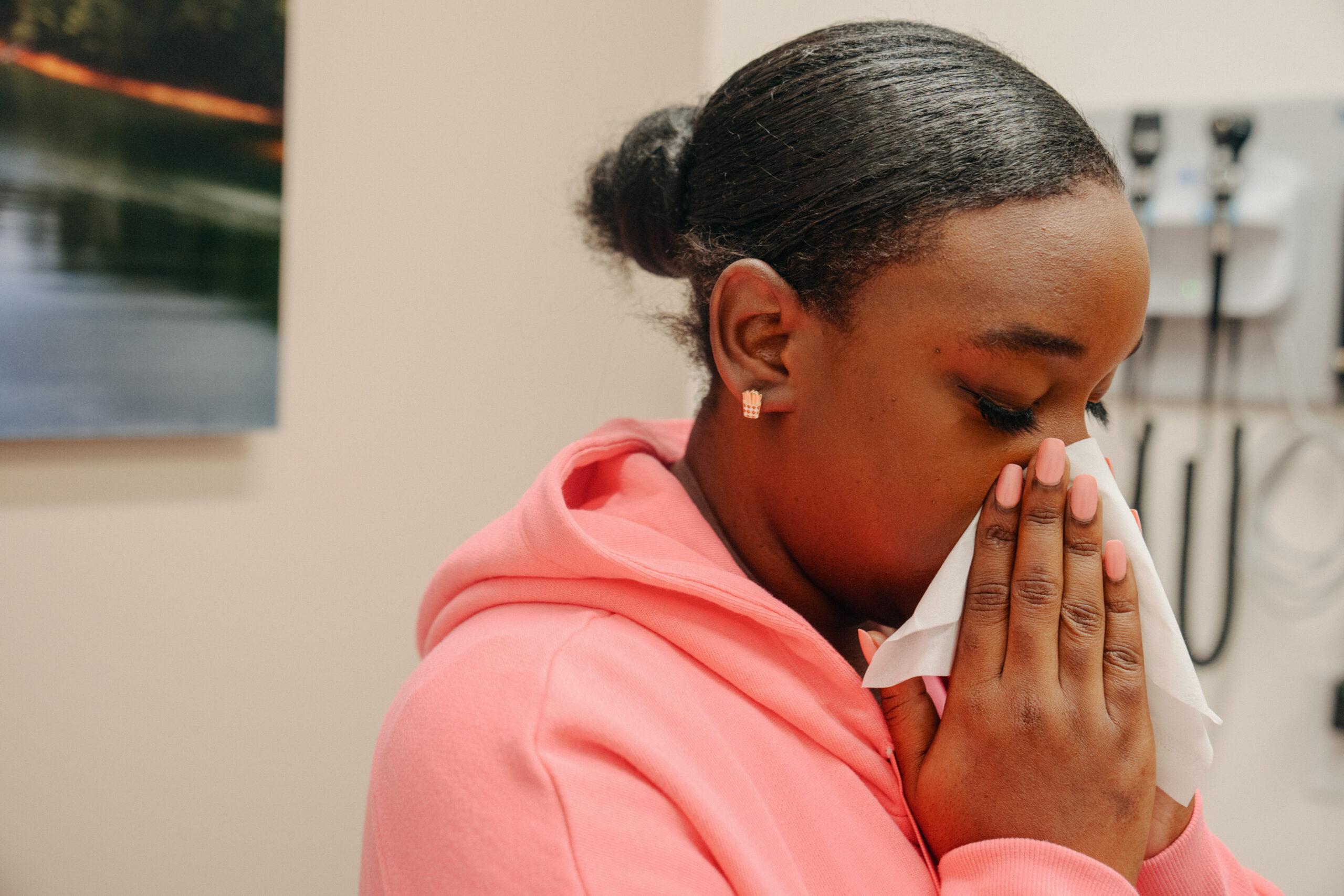 A young lady deals with a runny nose.