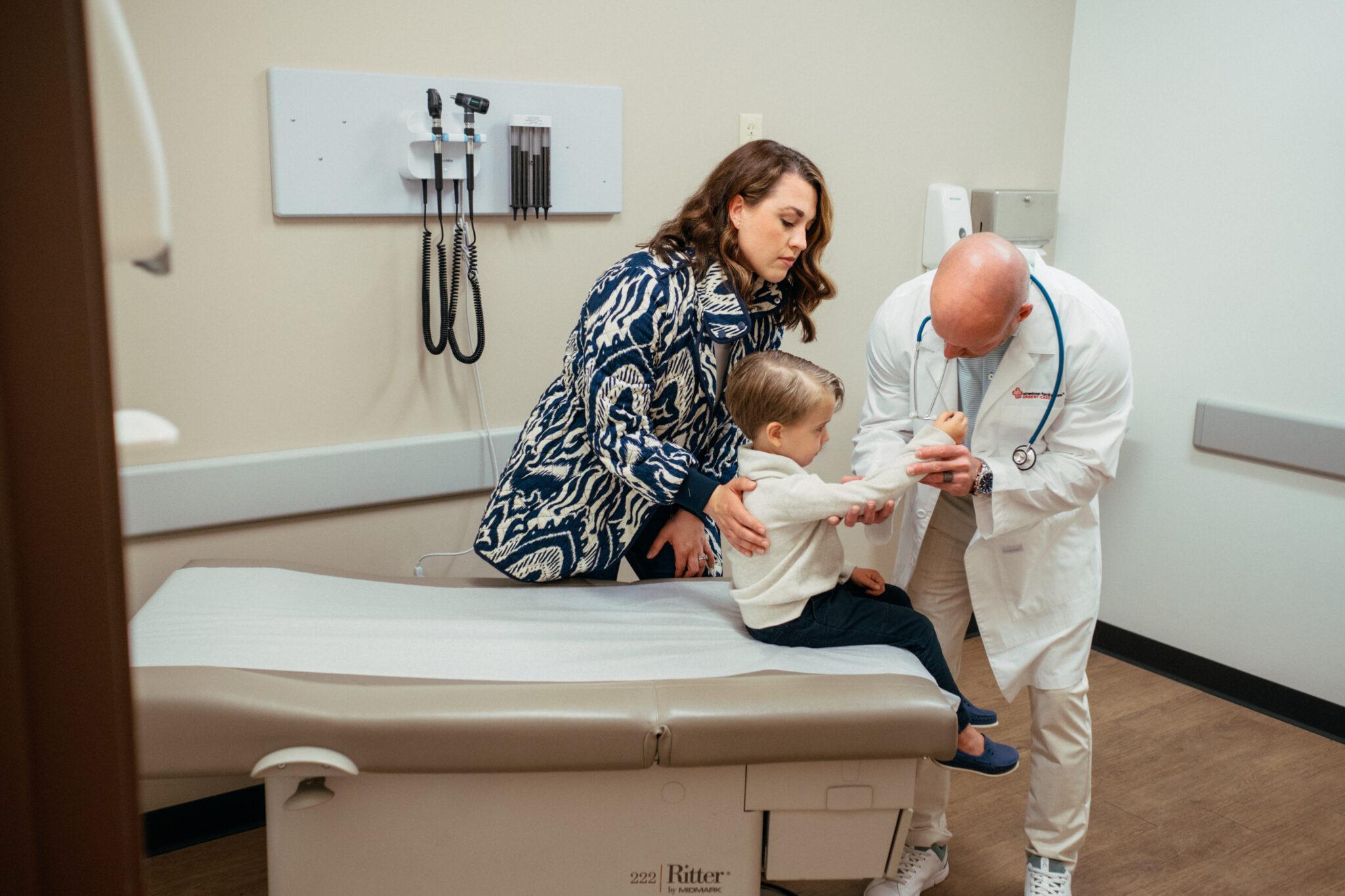 Child getting arm checked by medical professional.