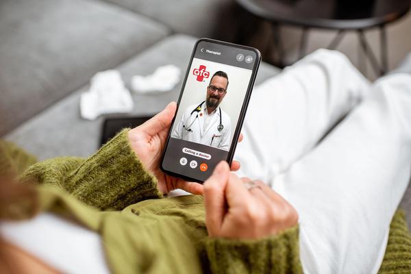 Patient on a video call with an AFC provider on a smartphone