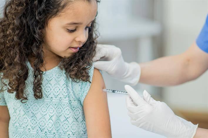 AFC provider giving a child a vaccination